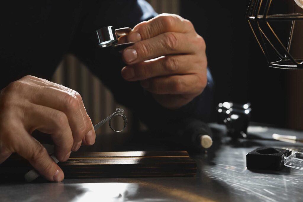 A broker in pawn shop checking diamond ring
